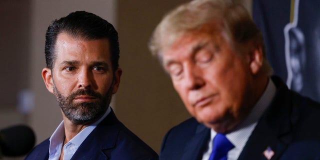 Donald Trump Jr. and former President of the United States Donald Trump look on prior to the fight between Evander Holyfield and Vitor Belfort during Evander Holyfield vs. Vitor Belfort presented by Triller at Seminole Hard Rock Hotel & Casino on September 11, 2021 in Hollywood, Florida.