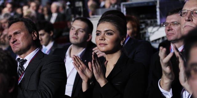 Russian politician and former Olympic Champion Alina Kabaeva applauds as Prime Minister Vladimir Putin delivers his speech at the congress of the United Russia Party Nov. 27, 2011, in Moscow.