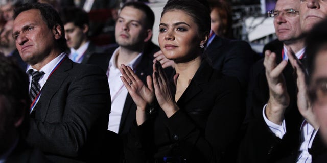 Russian politician and former Olympic Champion Alina Kabaeva applauds as Prime Minister Vladimir Putin delivers his speech at the congress of the United Russia Party Nov. 27, 2011, in Moscow.