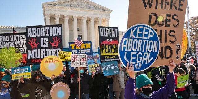 Demonstrators gather in front of the U.S. Supreme Court as justices hear arguments in the Mississippi abortion case.