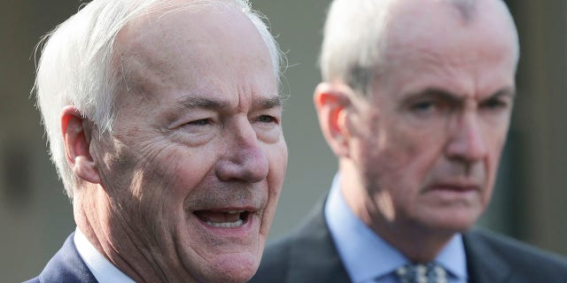 Arkansas Gov. Asa Hutchinson (L) (R-AR), Chairman of the National Governors Association, and New Jersey Gov. Phil Murphy (D-NJ) (R) speak outside the White House after a meeting with U.S. President Joe Biden and members of the National Governors Association on January 31, 2022 in Washington, DC.