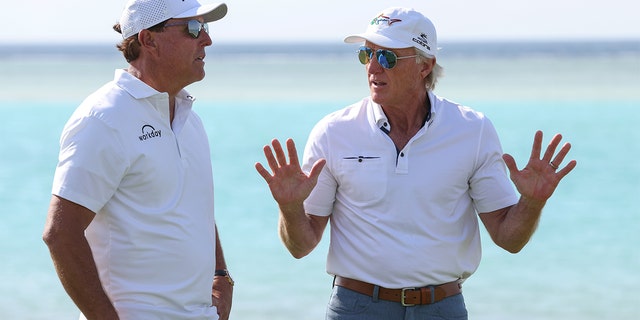 USA's Phil Mickelson and Liv Golf Investments CEO Greg Norman interact during a practice round ahead of the PIF Saudi International at Royal Greens Golf &  Country Club on February 2, 2022 in Al Murooj, Saudi Arabia.