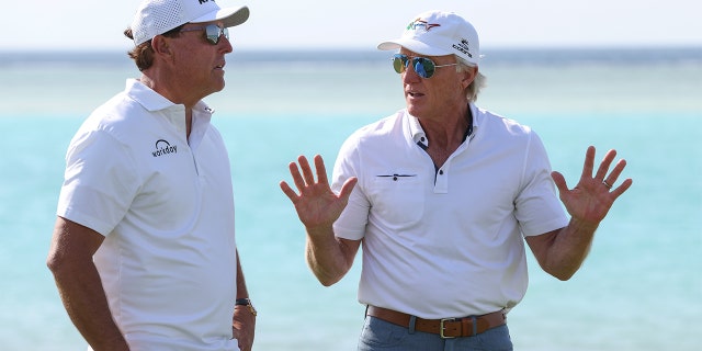 USA's Phil Mickelson and Liv Golf Investments CEO Greg Norman interact during a practice round ahead of the PIF Saudi International at Royal Greens Golf & Country Club on February 2, 2022 in Al Murooj, Saudi Arabia.
