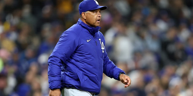 Manager Dave Roberts of the Los Angeles Dodgers walks to the mound during a game against the San Diego Padres at PETCO Park April 22, 2022, in San Diego.