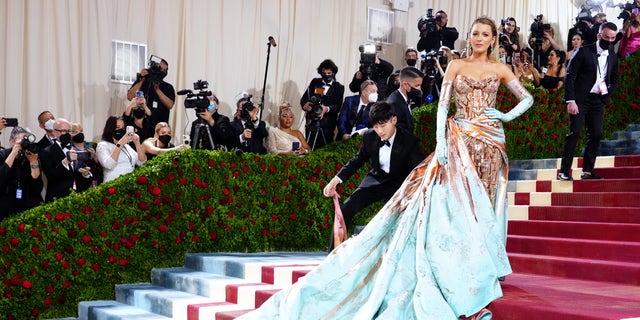 Blake Lively attends The 2022 Met Gala in a custom Versace gown that transformed as she was halfway up the red carpet on Monday night.