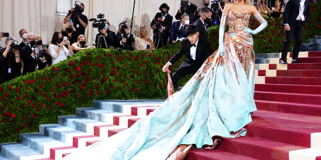 Blake Lively attends The 2022 Met Gala in a custom Versace gown that transformed as she was halfway up the red carpet on Monday night.