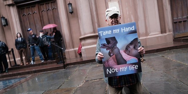 Anti-abortion activists confront a gathering of abortion-rights demonstrators outside of a Catholic church in downtown Manhattan on May 7, 2022 in New York City.