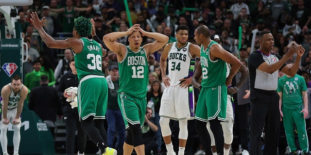 Grant Williams (12) and Marcus Smart (36) of the Boston Celtics react to an official's call during Game 3 of the Eastern Conference semifinals against the Milwaukee Bucks at Fiserv Forum May 7, 2022, in Milwaukee.