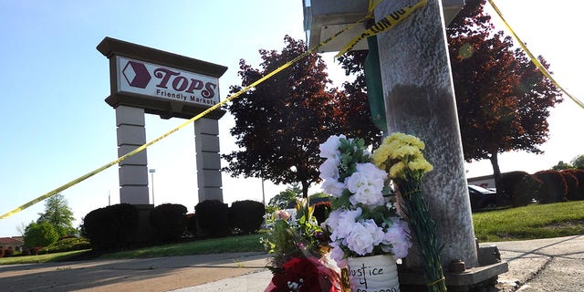 Flowers are left at a makeshift memorial outside of Tops market on May 15, 2022, in Buffalo, New York. 