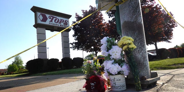 Flowers are left at a makeshift memorial outside of Tops market on May 15, 2022, in Buffalo, New York.