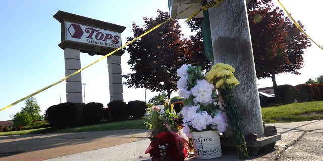 Flowers are left at a makeshift memorial outside of Tops market on May 15, 2022, in Buffalo, New York. 