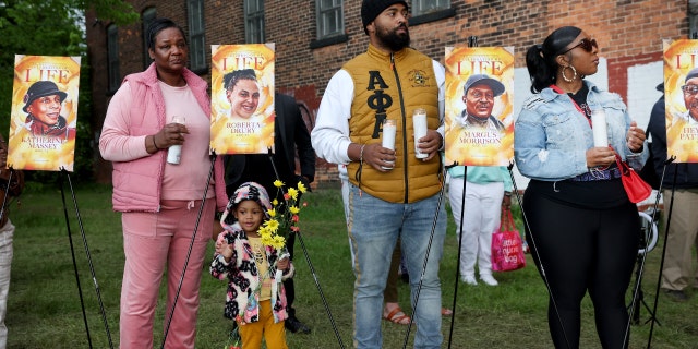 People participate in a vigil to honor the 10 people killed in Saturday's shooting at Tops market on May 17, 2022 in Buffalo, New York.