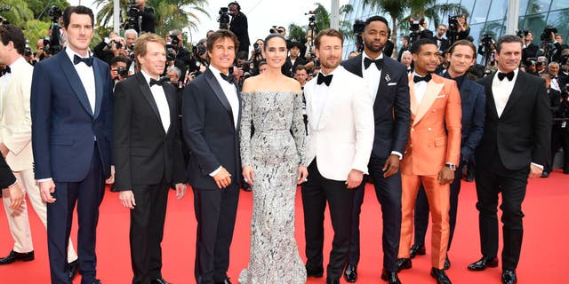 Director Joseph Kosinski, Jerry Bruckheimer, Tom Cruise, Jennifer Connelly, Glen Powell, Jay Ellis, Greg Tarzan Davis, Lewis Pullman and Jon Hamm attend the screening of "Top Gun: Maverick" during the 75th annual Cannes film festival at Palais des Festivals on May 18, 2022.