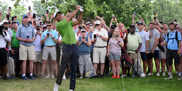 Tiger Woods plays his second shot on the first hole of the PGA Championship at Southern Hills Country Club on May 20, 2022, in Tulsa, Oklahoma.