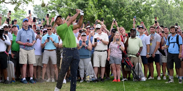 Tiger Woods plays his second shot on the first hole of the PGA Championship at Southern Hills Country Club on May 20, 2022, in Tulsa, Oklahoma.