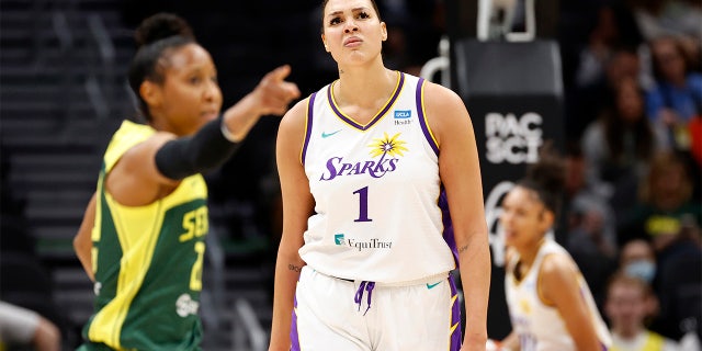 Briann January, left, of the Seattle Storm, and Liz Cambage (1) of the Los Angeles Sparks during the first half at Climate Pledge Arena May 20, 2022, in Seattle.