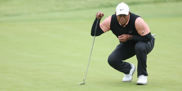 Tiger Woods of the United States lines up a putt on the 12th green during the third round of the 2022 PGA Championship at Southern Hills Country Club on May 21, 2022.