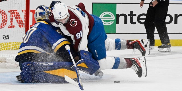 Colorado Avalanche center Nazem Kadri (91) crashes into St. Louis Blues goaltender Jordan Binnington (50) in the first period at the Enterprise Center during Game 3 of the second round of the NHL playoffs May 21, 2022.