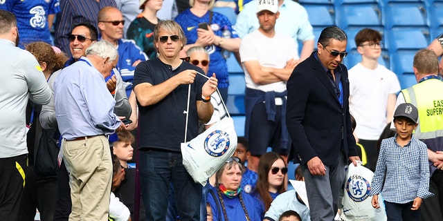 Chelsea's prospective U.S. owner Todd Boehly, left, holding a Chelsea bag as the Chelsea team completes a lap of honor after a Premier League match between Chelsea and Watford at Stamford Bridge May 22, 2022, in London.