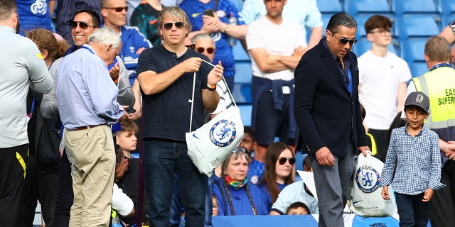 Chelsea's prospective U.S. owner Todd Boehly, left, holding a Chelsea bag as the Chelsea team completes a lap of honor after a Premier League match between Chelsea and Watford at Stamford Bridge May 22, 2022, in London.