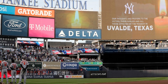 A moment of silence is observed for victims of the Texas elementary school massacre at Yankee Stadium prior to a game between the New York Yankees and the Baltimore Orioles on May 25, 2022, in New York City.