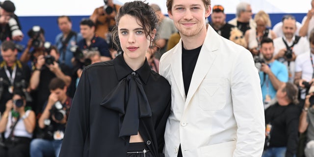 Margaret Qualley and Joe Alwyn attend the photocall for "stars at noon" during the 75th Cannes Film Festival.