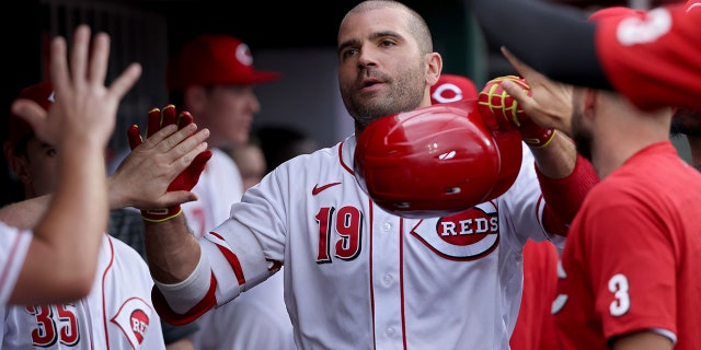 Joey Votto #19 of the Cincinnati Reds celebrates with teammates after hitting a home run in the second inning against the Chicago Cubs at Great American Ball Park on May 25, 2022 in Cincinnati, Ohio.