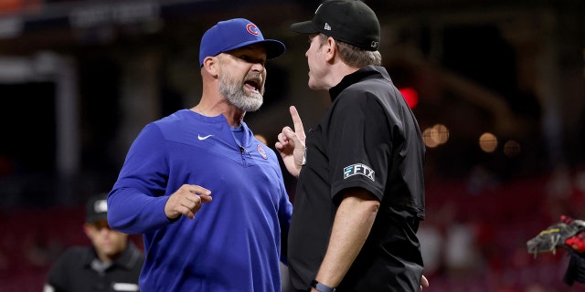 Manager David Ross of the Chicago Cubs and umpire Chris Conroy argue after Ross was ejected in the ninth inning against the Cincinnati Reds at Great American Ball Park May 25, 2022, in Cincinnati.