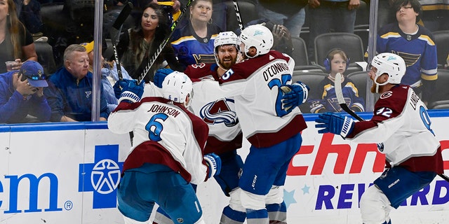 From left, Colorado Avalanche defenseman Erik Johnson (6), center Darren Helm (43), right wing Logan O'Connor (25) and left wing Gabriel Landeskog (92) celebrate the Helm's game-winning goal against the St. Louis Blues in the third period of Game 6 of the second round of the NHL Stanley Cup Playoffs at Enterprise Center on May 27, 2022.
