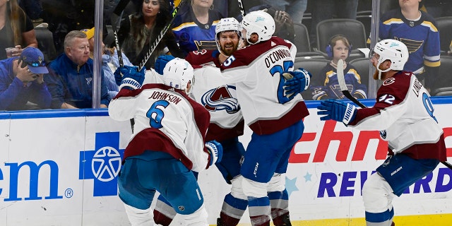 From left, Colorado Avalanche defenseman Erik Johnson (6), center Darren Helm (43), right wing Logan O'Connor (25) and left wing Gabriel Landeskog (92) celebrate the Helm's game-winning goal against the St. Louis Blues in the third period of Game 6 of the second round of the NHL Stanley Cup Playoffs at Enterprise Center on May 27, 2022.