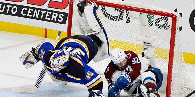 Colorado Avalanche left winger Gabriel Landeskog (92) slides into the net, knocking down St. Louis Blues goaltender Ville Husso (35) in the third period in Game 6 of the second round of the playoffs at the NHL Stanley Cup at the Enterprise Center on May 27, 2022. 