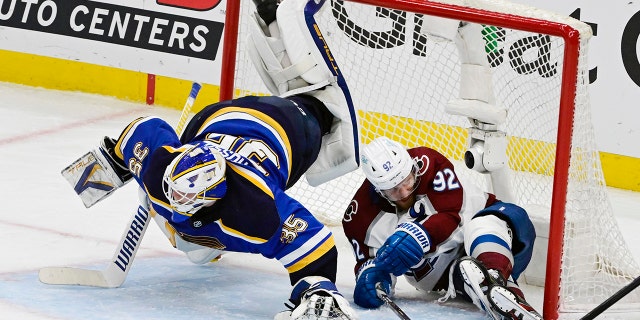 Colorado Avalanche left winger Gabriel Landeskog (92) slides into the net, knocking down St. Louis Blues goaltender Ville Husso (35) in the third period in Game 6 of the second round of the playoffs at the NHL Stanley Cup at the Enterprise Center on May 27, 2022.