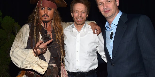 (L-R) Actor Johnny Depp, dressed as Captain Jack Sparrow and producer Jerry Bruckheimer of "Pirates of the Caribbean: Dead Men Tell No Tales" with President of Walt Disney Studios Motion Picture Production Sean Bailey.