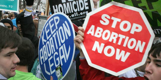 Pro-life demonstrators confront pro-choice counterparts in January 2006 in Washington, D.C. Abortion has been legal in the U.S. since the Supreme Court's Roe v. Wade decision in 1973. (AFP PHOTO/Karen BLEIER)