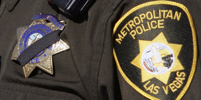 Las Vegas Metropolitan Police Department Lt. Dan McGrath wears a shrouded badge as he attends the funeral for LVMPD Sgt. Henry Prendes.