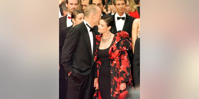 Bruce Willis and wife Demi Moore arrive for the premiere of "The Fifth Element" at the 50th Cannes Film Festival.