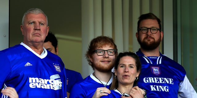 Ed Sheeran and Cherry Seaborn watch the Sky Bet Championship match in April 2018. The couple announced their engagement that same year.