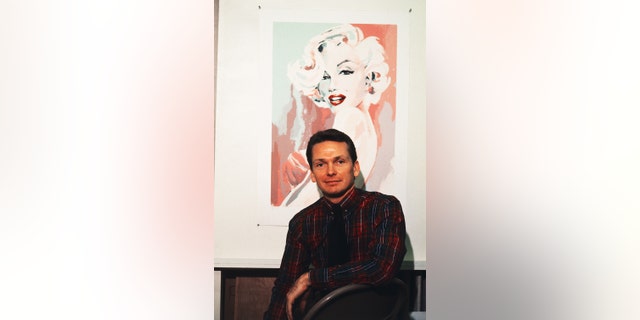 Bob Mackie, leading costume designer, poses with his serigraph of actress Marilyn Monroe at the Far Gallery.