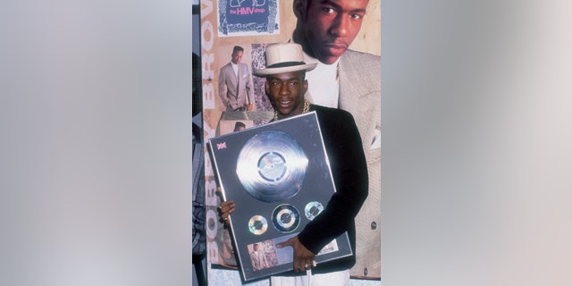 Bobby Brown holding a copy of his album "Don't Be Cruel," circa 1988.