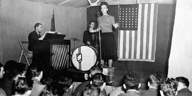 Carole Landis, American movie star, entertains personnel of an Eight Air Force station during her visit to Northern Ireland. 