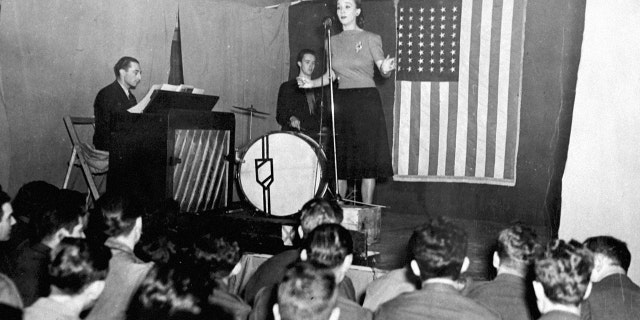 Carole Landis, American movie star, entertains personnel of an Eight Air Force station during her visit to Northern Ireland.
