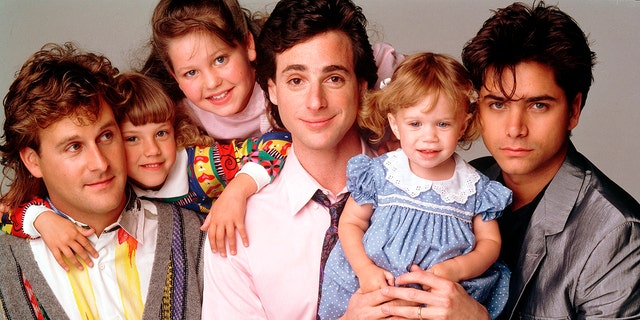 Left to right: Dave Coulier, Jodie Sweetin, Candace Cameron Bure, Bob Saget, Mary-Kate / Ashley Olson and John Stamos starring in "Full House" in 1989.