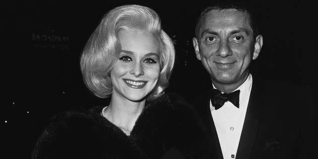 American film and television producer Aaron Spelling (1923 - 2006) with actress Diane McBain at a party for the film 'The Greatest Story Ever Told', 1965. 