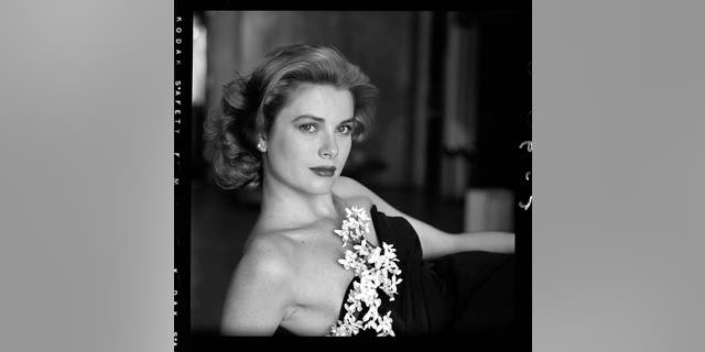 Grace Kelly in a strapless gown with a sprig of flowers tucked into her bodice, Hollywood, California, March 1954.