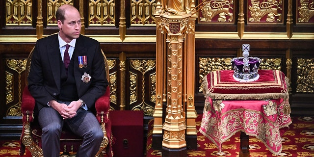 Prince William, Duke of Cambridge, sits by The Imperial State Crown in the House of Lords Chamber, during the State Opening of Parliament at the Palace of Westminster on May 10, 2022, in London, England.