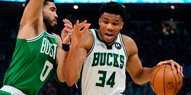 Milwaukee Bucks' Giannis Antetokounmpo gets past Boston Celtics' Jayson Tatum during the first half of Game 3 of an NBA basketball Eastern Conference semifinals playoff series Saturday, May 7, 2022, in Milwaukee.