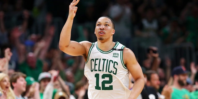 Grant Williams #12 of the Boston Celtics reacts after making a three point basket during the third quarter against the Milwaukee Bucks in Game Seven of the 2022 NBA Playoffs Eastern Conference Semifinals at TD Garden on May 15, 2022 in Boston, Massachusetts.