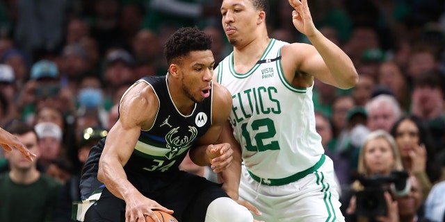 Grant Williams #12 of the Boston Celtics defends Giannis Antetokounmpo #34 of the Milwaukee Bucks during the first quarter in Game Seven of the 2022 NBA Playoffs Eastern Conference Semifinals at TD Garden on May 15, 2022 in Boston, Massachusetts.