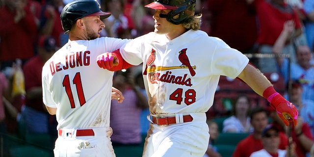 St. Louis Cardinals' Harrison Bader (48) is congratulated by teammate Paul DeJong (11) after hitting a two-run home run during the seventh inning of a baseball game against the Arizona Diamondbacks Sunday, May 1, 2022, in St. Louis.