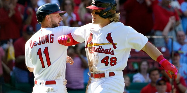St. Louis Cardinals' Harrison Bader (48) is congratulated by teammate Paul DeJong (11) after hitting a two-run home run during the seventh inning of a baseball game against the Arizona Diamondbacks Sunday, May 1, 2022, in St. Louis.